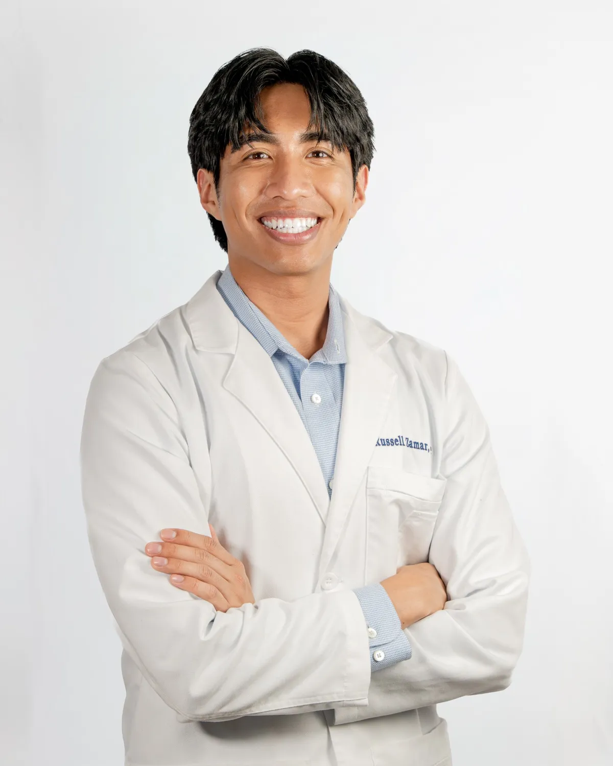 Russell Zamar, PA, in his white coat, arms crossed and smiling